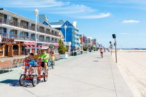 Sunny Boardwalk image with people riding bikes