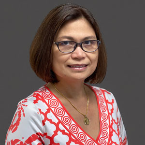 a woman wearing glasses and a red and white shirt
