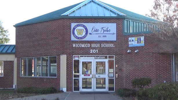 the front entrance of a school building with its doors open