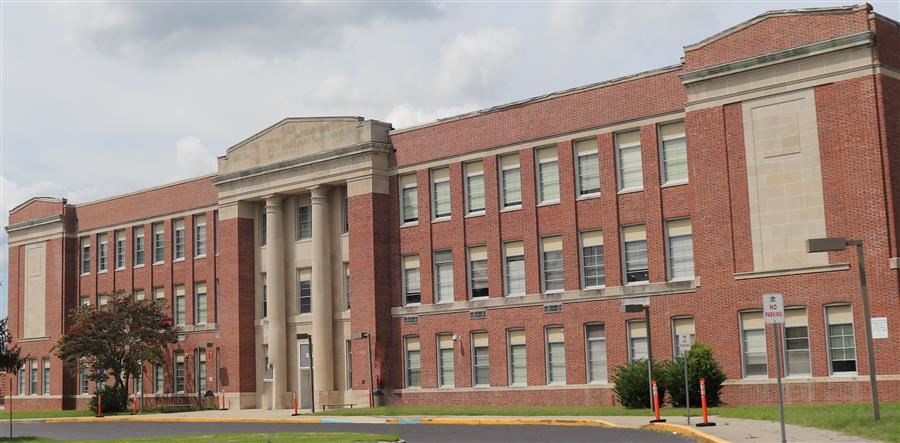 a large brick building with columns and windows