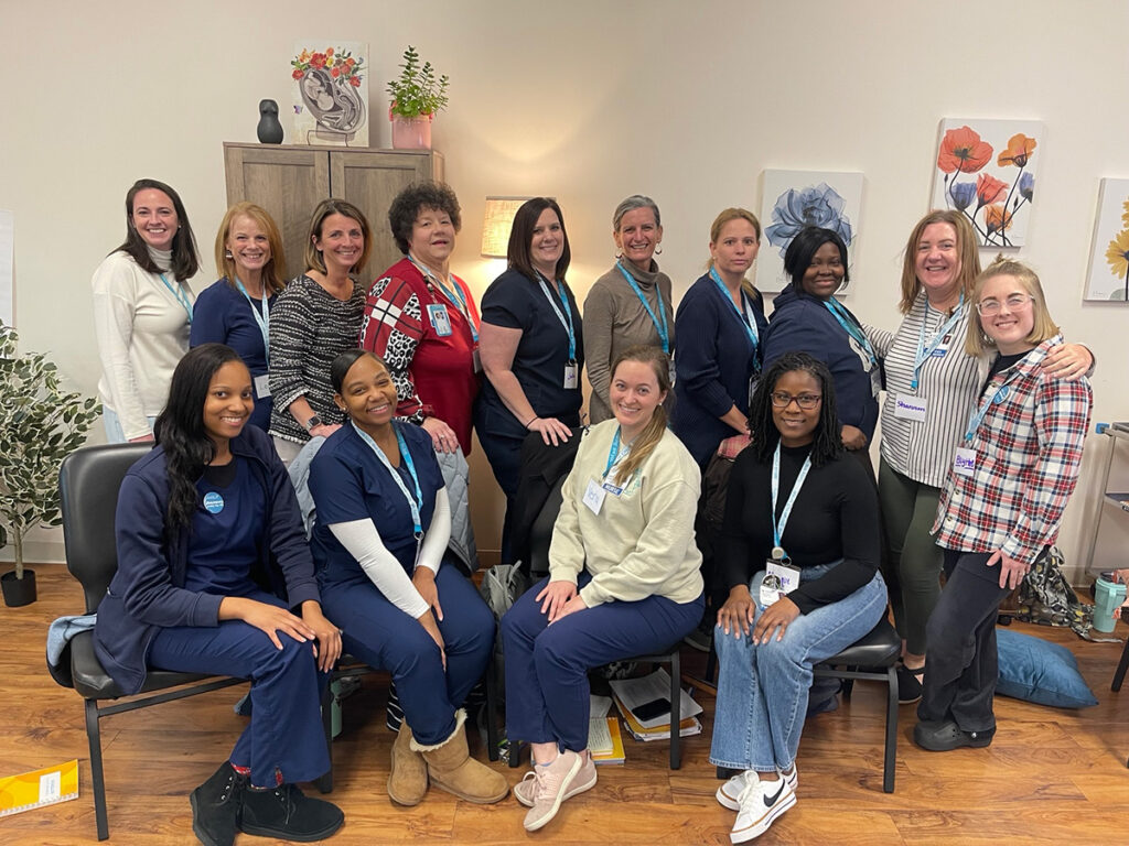 a group of women in scrubs posing for a photo