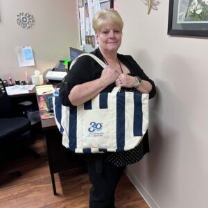 a woman is holding a large bag in her hands