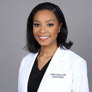 a woman wearing a white lab coat and black shirt