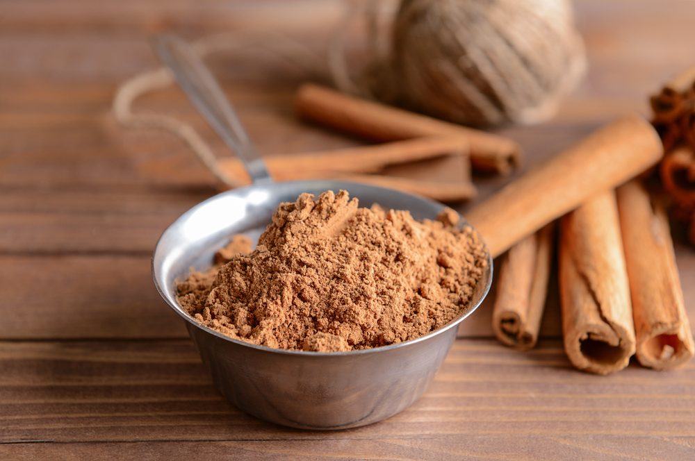 cinnamon sticks and cinnamon powder in a metal bowl