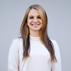 a woman with long hair wearing a white shirt