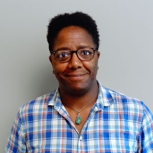 a man wearing glasses and a plaid shirt