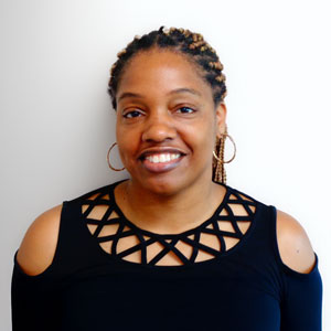 a woman in a black top smiling at the camera
