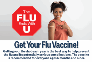a woman holding a red stop sign with the words get your flu vaccine