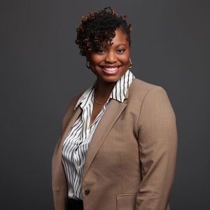 a woman in a business suit posing for a picture
