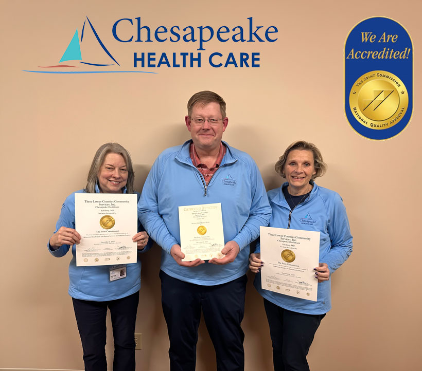 a group of people standing next to each other holding plaques